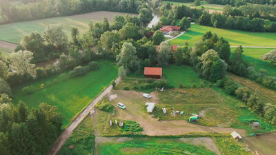 Drohnenaufnahme einer ländlichen Landschaft mit Bauernhof und Wiesen