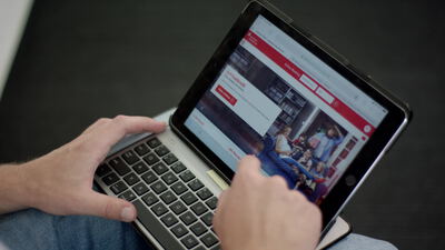Hände bedienen ein Tablet beim Onlineshopping im Internet