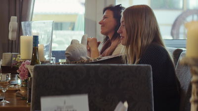 Zwei Frauen unterhalten sich fröhlich in einem Restaurant