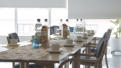 Gedeckter Tisch für eine Kaffeepause im hellen Seminarraum