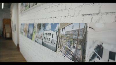 Gerahmte Architektur Renderings an einer weißen Ziegelwand