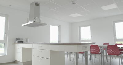 Helle moderne Küche mit Essbereich und roten Stühlen