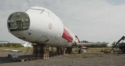 Ausgemusterte Flugzeugnase steht auf Holzpaletten auf einem Flugzeugfriedhof