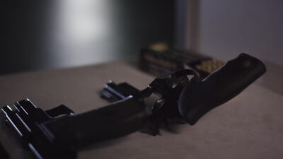 Pistole und Revolver liegen mit Munition auf einem Tisch Pistole und Revolver liegen mit Munition auf einem Tisch, Pistole auf Tisch, Revolver auf Tisch und Handfeuerwaffe als 4K