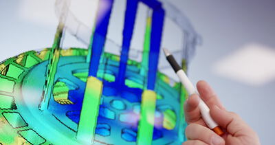 Hand zeigt auf eine bunte 3D Simulation am Bildschirm