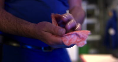 Metzger formt frisches rohes Fleisch mit bloßen Händen